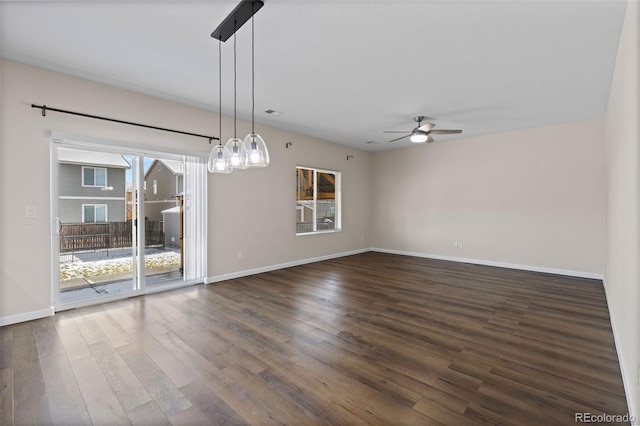 spare room with dark hardwood / wood-style floors and ceiling fan