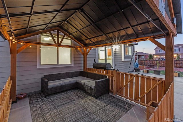 deck at dusk featuring area for grilling, a gazebo, and an outdoor hangout area