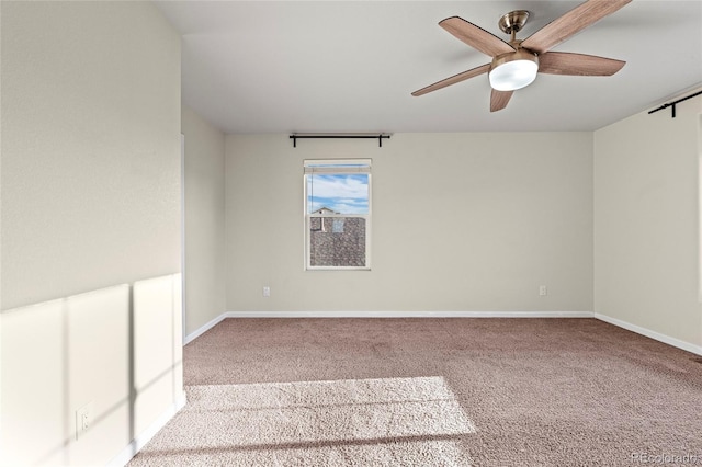 unfurnished room with light colored carpet and ceiling fan