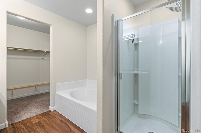 bathroom featuring hardwood / wood-style floors and shower with separate bathtub