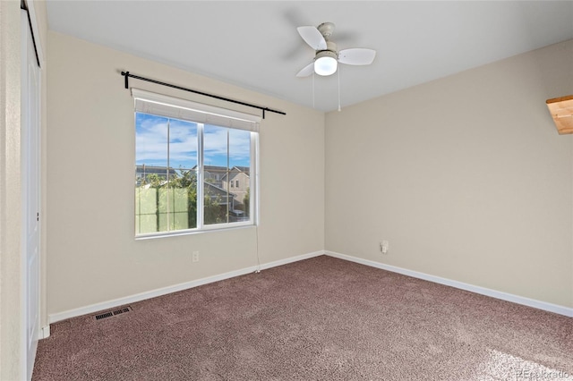 carpeted empty room featuring ceiling fan