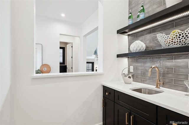 interior space with backsplash and sink