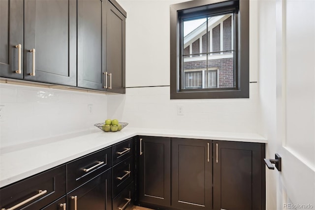 kitchen featuring dark brown cabinetry and backsplash