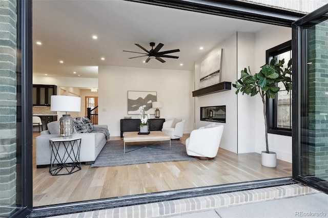 living room featuring hardwood / wood-style flooring and ceiling fan