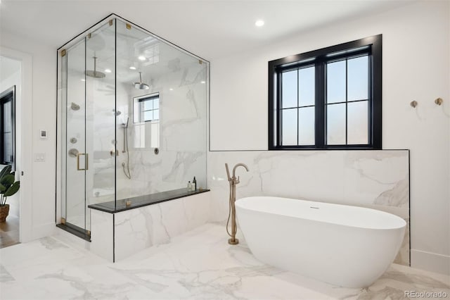 bathroom with a wealth of natural light, tile walls, and shower with separate bathtub