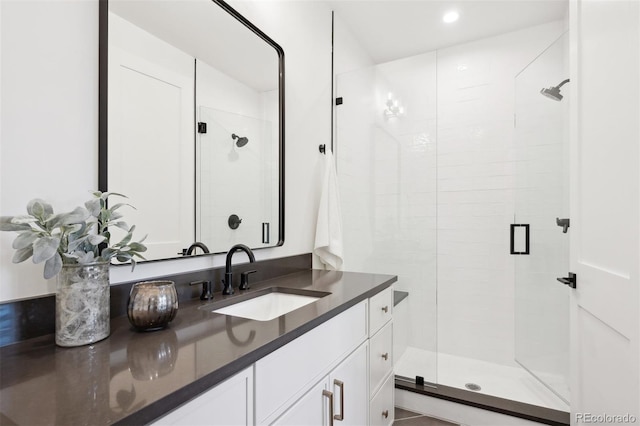 bathroom featuring vanity and a shower with shower door