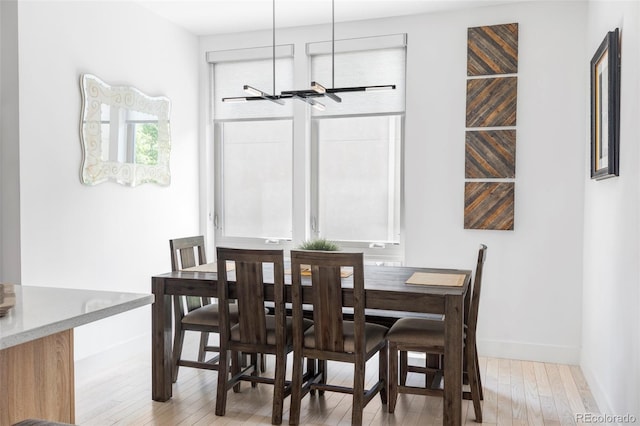 879 Delaware St, Denver, CO 80204 - dining space with light wood-style flooring and baseboards