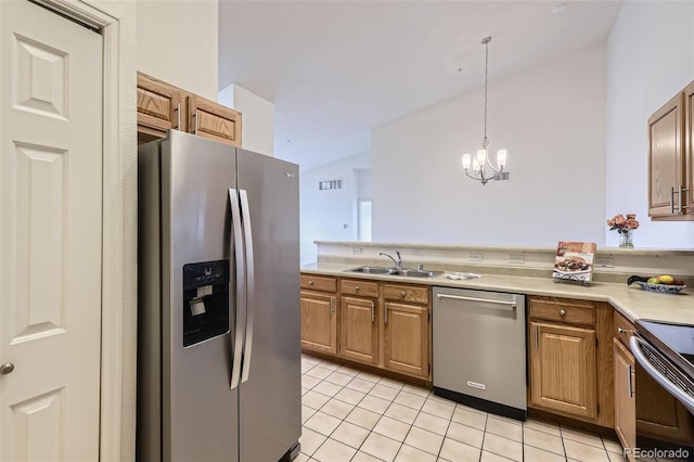 kitchen with light tile patterned floors, stainless steel appliances, a sink, and light countertops