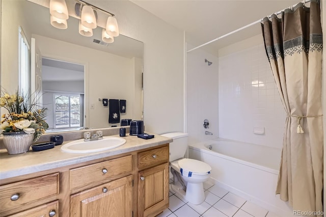 bathroom with toilet, vanity, visible vents, tile patterned floors, and shower / bath combo