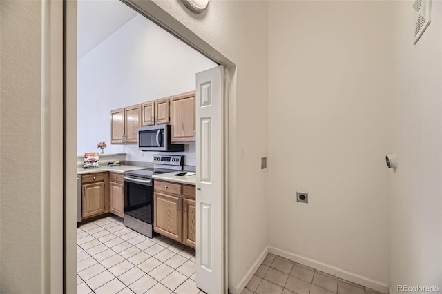 kitchen with visible vents, baseboards, appliances with stainless steel finishes, light countertops, and light tile patterned flooring