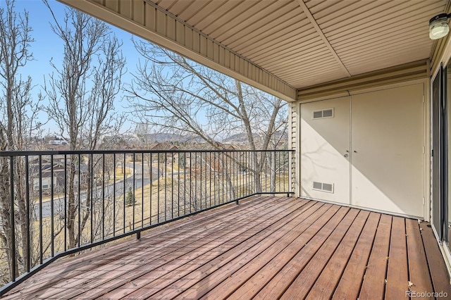 wooden terrace featuring visible vents