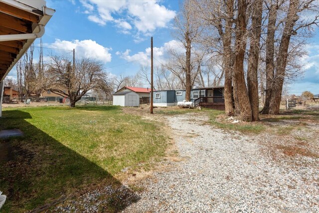 8005 W US Highway 50, Salida, CO 81201 - view of grassy yard with driveway, an outdoor structure, and a shed