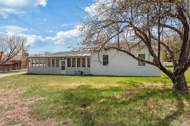 8005 W US Highway 50, Salida, CO 81201 - rear view of house with a sunroom and a lawn