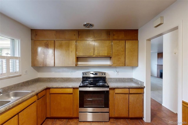 820 Cottonwood Ave, Centennial, CO 80121 - kitchen with stainless steel electric stove, light tile patterned floors, open shelves, brown cabinets, and a fireplace