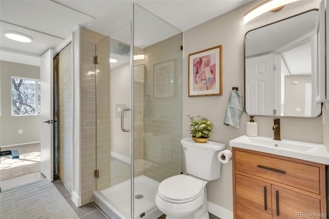 full bathroom with a shower stall, toilet, vanity, and baseboards