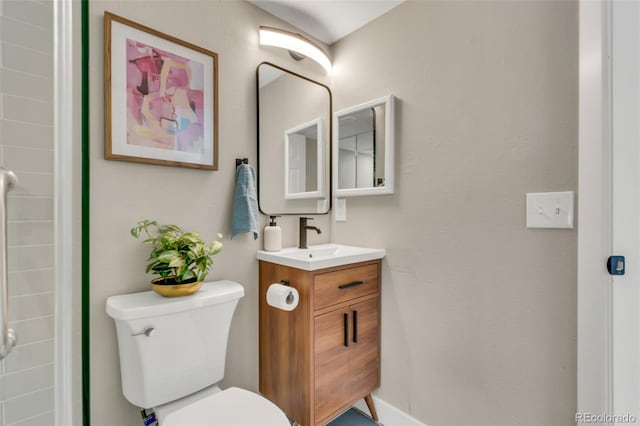 bathroom featuring toilet and vanity
