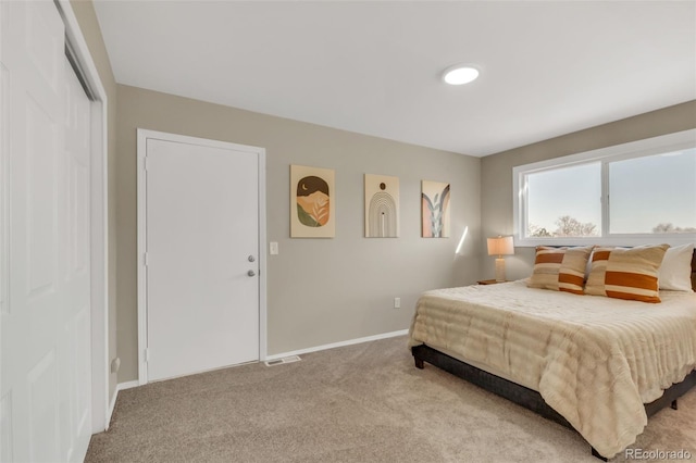 bedroom featuring light colored carpet, baseboards, and visible vents
