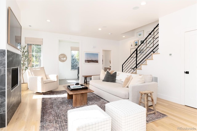 living room with a fireplace and light hardwood / wood-style flooring