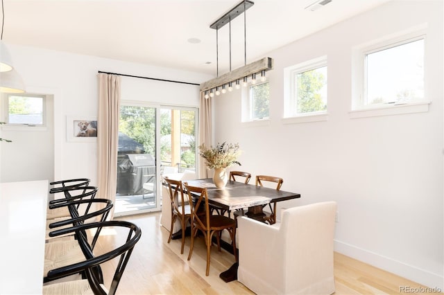 dining space with light hardwood / wood-style flooring