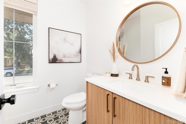 bathroom featuring tile patterned floors, vanity, and toilet