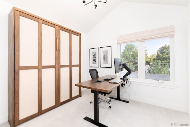 carpeted home office with lofted ceiling