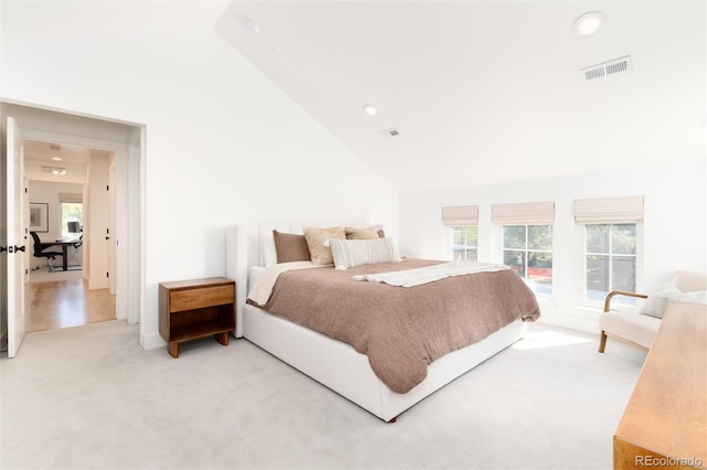 bedroom featuring carpet flooring, high vaulted ceiling, and multiple windows