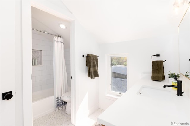 full bathroom featuring toilet, vaulted ceiling, vanity, and shower / bath combo with shower curtain