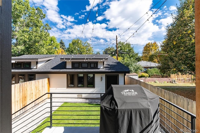 rear view of property featuring a yard