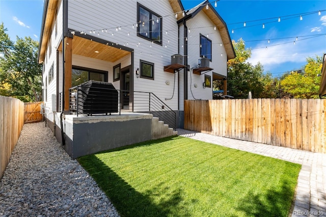 rear view of house featuring a lawn