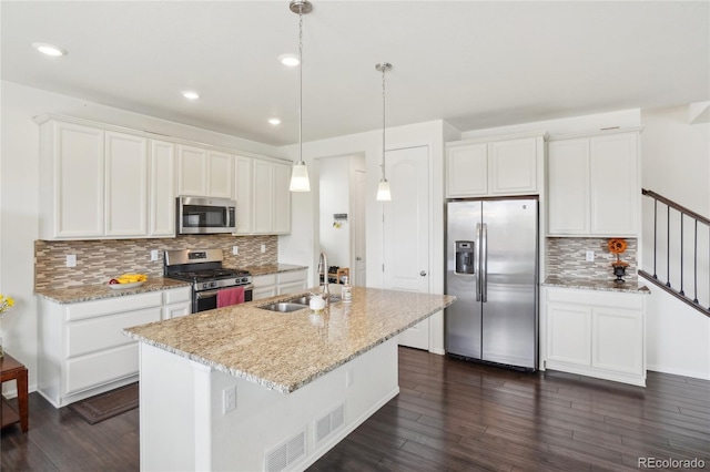 2682 E 161st Pl, Thornton, CO 80602 - kitchen with appliances with stainless steel finishes, a sink, backsplash, dark wood finished floors, and recessed lighting