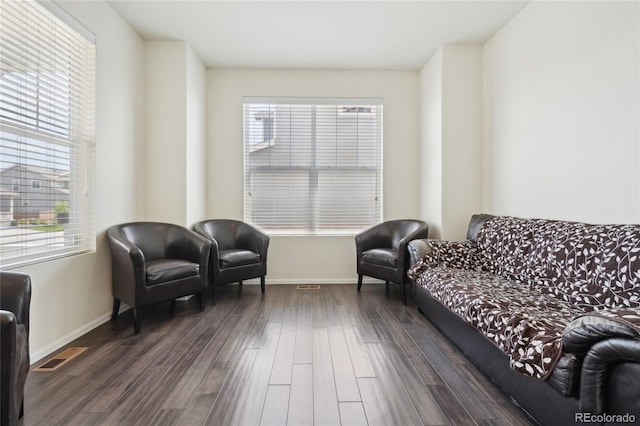 2682 E 161st Pl, Thornton, CO 80602 - living area featuring plenty of natural light, dark wood finished floors, and baseboards