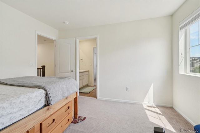 2682 E 161st Pl, Thornton, CO 80602 - bedroom featuring light colored carpet, baseboards, and ensuite bath
