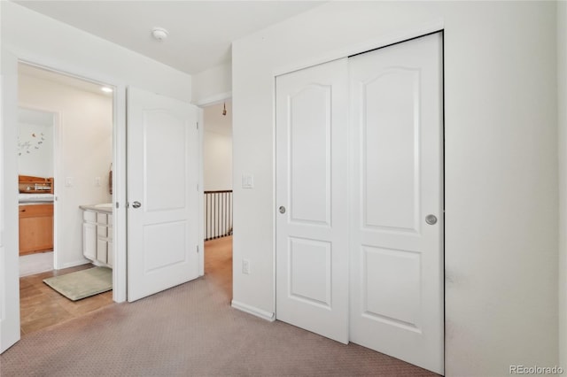 2682 E 161st Pl, Thornton, CO 80602 - unfurnished bedroom featuring a closet, light carpet, and ensuite bath