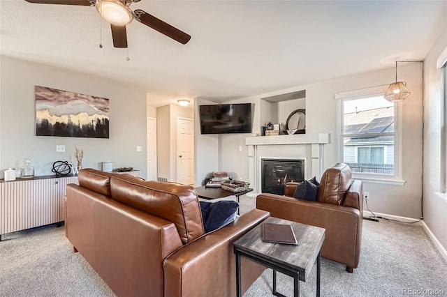 carpeted living room with ceiling fan