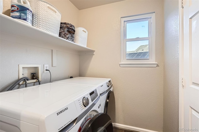 clothes washing area with washing machine and dryer