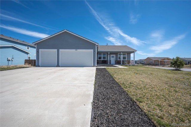 single story home featuring an attached garage, driveway, a front lawn, and covered porch