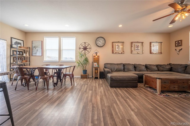 living area featuring baseboards, wood finished floors, recessed lighting, and ceiling fan