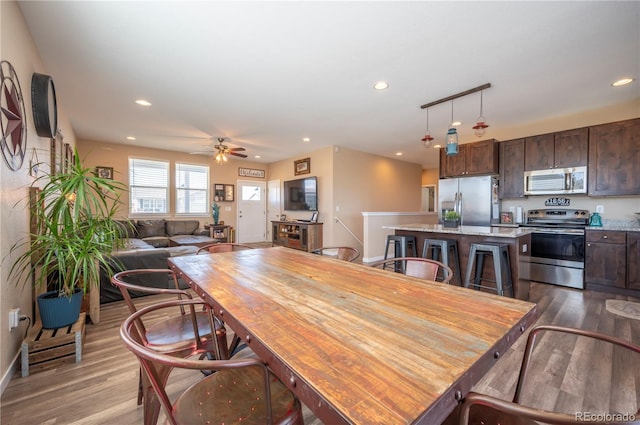 dining space with recessed lighting, wood finished floors, and ceiling fan