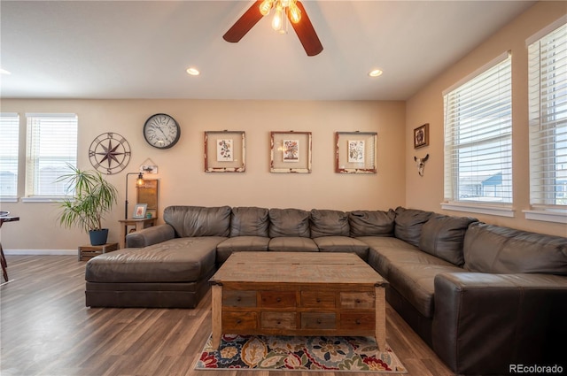 living area with baseboards, a ceiling fan, wood finished floors, and recessed lighting