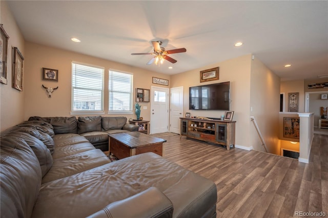 living room featuring ceiling fan, baseboards, wood finished floors, and recessed lighting