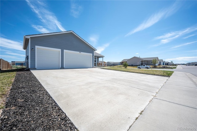 view of home's exterior featuring concrete driveway