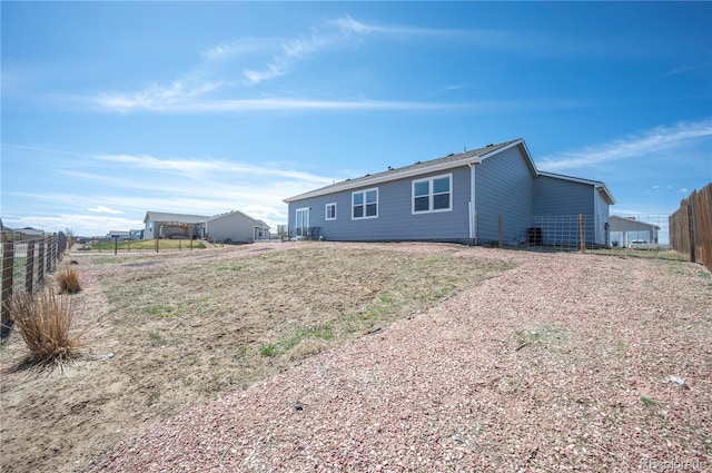 back of house featuring fence