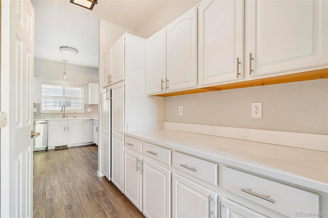 kitchen featuring white cabinetry, sink, and dishwasher