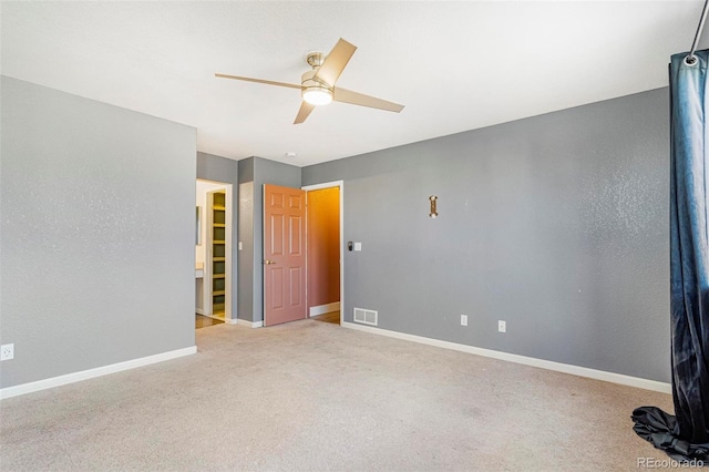 spare room featuring light colored carpet and ceiling fan