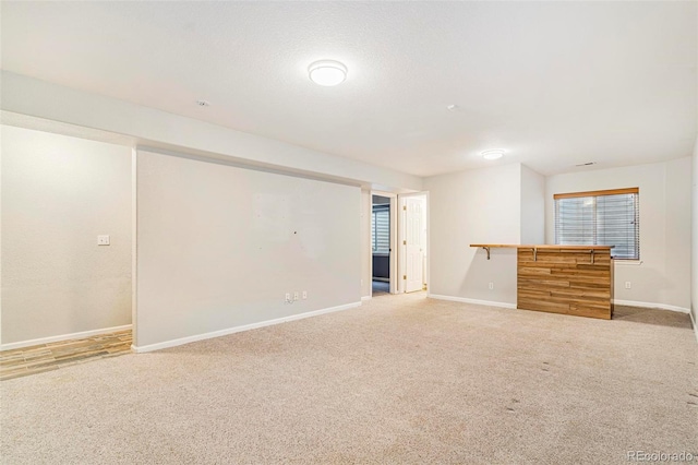 spare room with carpet flooring and a textured ceiling