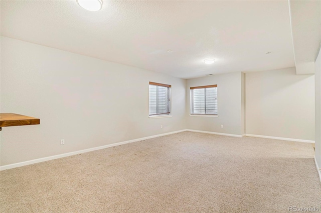 carpeted spare room featuring a textured ceiling