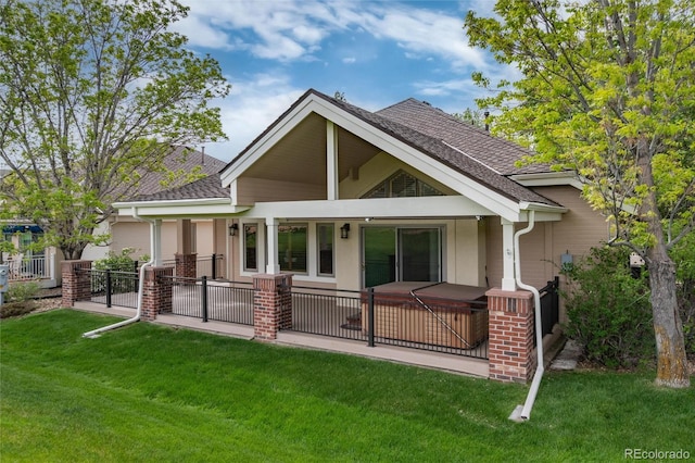 15851 Deer Ridge Dr, Morrison, CO 80465 - back of house with a hot tub, roof with shingles, and a patio