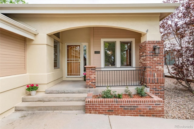 15851 Deer Ridge Dr, Morrison, CO 80465 - view of exterior entry with a porch and brick siding