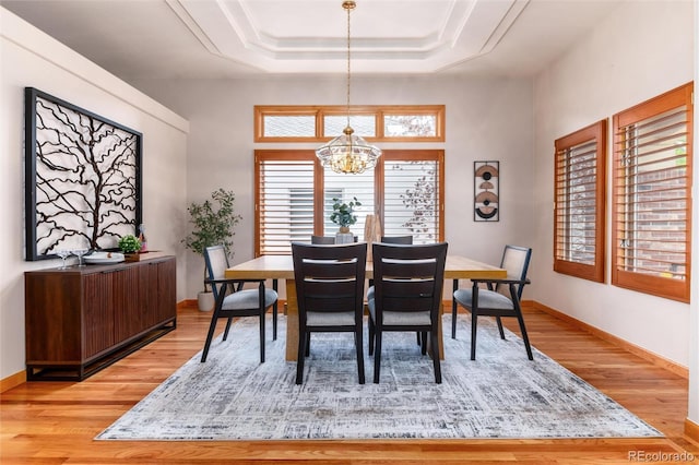 15851 Deer Ridge Dr, Morrison, CO 80465 - dining space with light wood-style floors, a chandelier, a tray ceiling, and baseboards