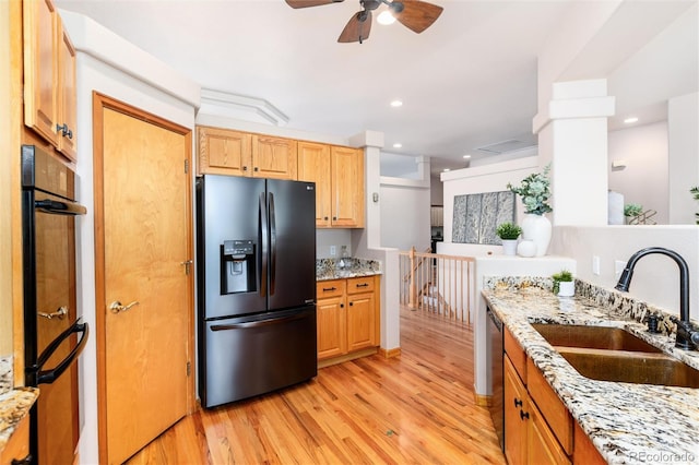 15851 Deer Ridge Dr, Morrison, CO 80465 - kitchen featuring black fridge with ice dispenser, a sink, light wood finished floors, ceiling fan, and light stone countertops